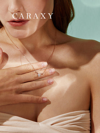 Model wearing a rose gold and white gold pendant necklace with a refined nature-inspired silhouette for everyday elegance.