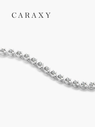 Side detail of a round brilliant diamond line bracelet showing the open gallery and link design in white gold.