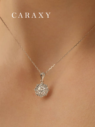Close-up of a round brilliant diamond pendant necklace with a refined starburst-inspired silhouette.