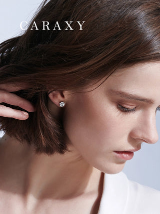 Model wearing round brilliant diamond studs in a close-up ear view.