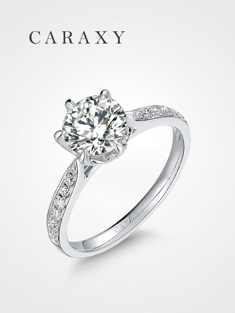 Classic round brilliant engagement ring with a micro pavé diamond band.