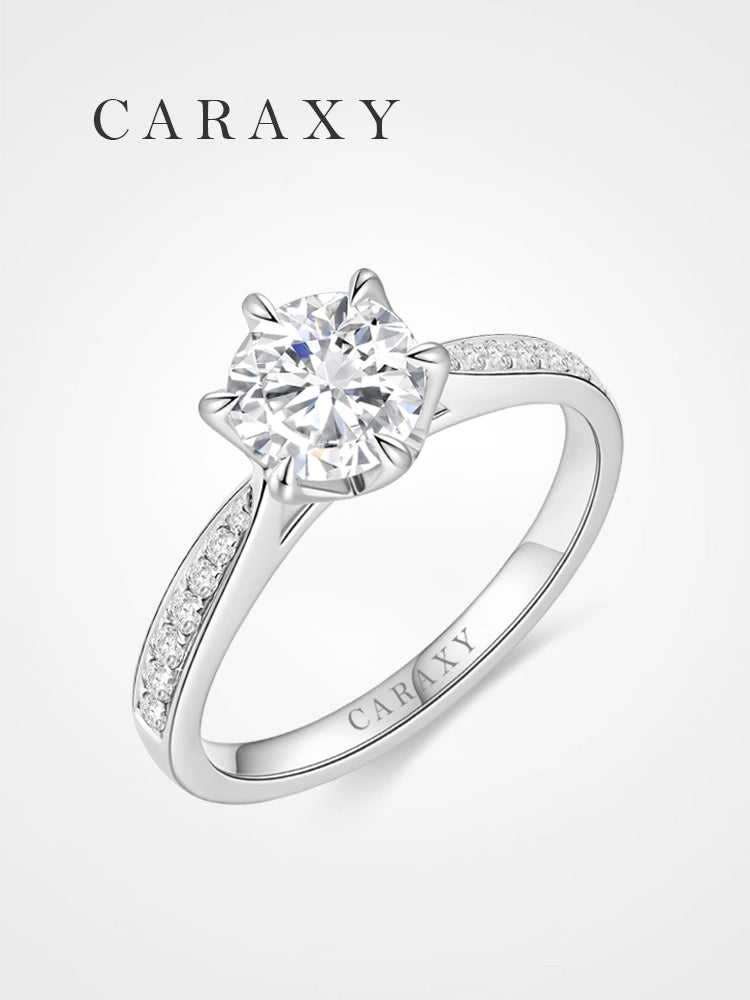 Classic round brilliant engagement ring with a micro pavé diamond band.