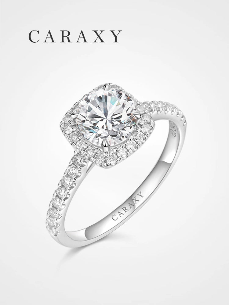 Round brilliant engagement ring with a cushion-shaped pavé halo and diamond band.