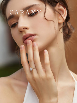 Model wearing a CARAXY round cut floral halo diamond ring in yellow gold and white gold