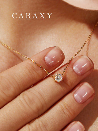 Detailed on-model view of a round diamond necklace in yellow gold with a timeless everyday look.