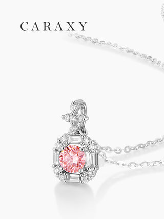 Close-up of a round fancy pink lab-grown diamond halo pendant necklace with baguette-cut side accents in 18K white gold.