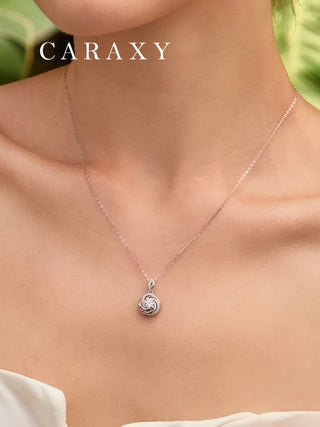 Close-up neckline view of round lab-grown diamond swirl pendant necklace