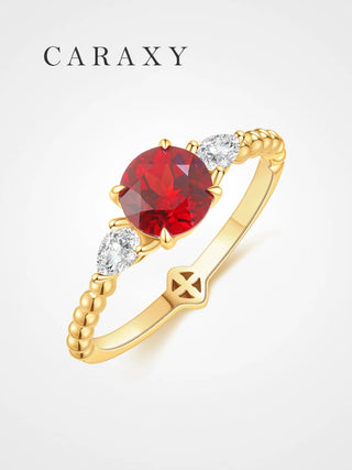 Round lab grown ruby ring with pear-shaped diamonds in 18K yellow gold