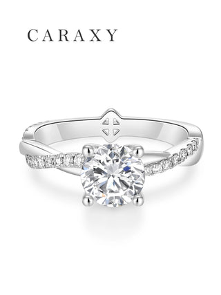 Front view of a round brilliant solitaire engagement ring featuring a twisted pavé band.