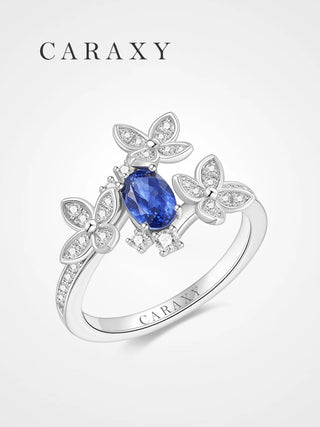 Royal blue sapphire statement ring with floral micro pavé details and a graceful bypass band.