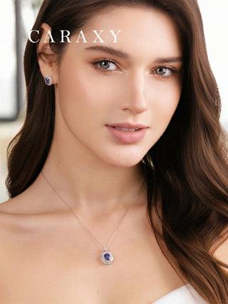 Model wearing a lab created sapphire birthstone necklace with matching sapphire earrings from the CARAXY Leaf Series.