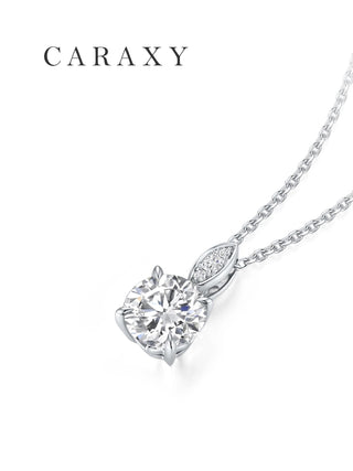 Angled view of a seed-inspired round diamond pendant in 18K white gold