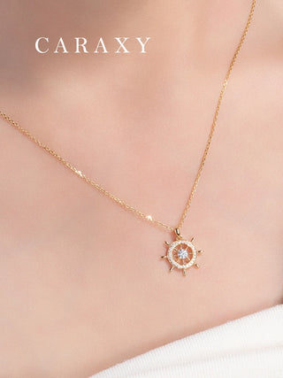 Model wearing a ship wheel diamond necklace in 18K yellow gold with a nautical-inspired openwork pendant and halo-like sparkle.