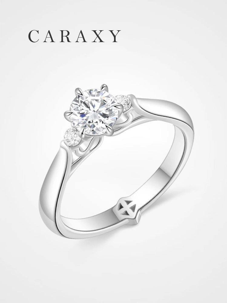 Side stone lab grown diamond engagement ring with a minimalist tapered band.