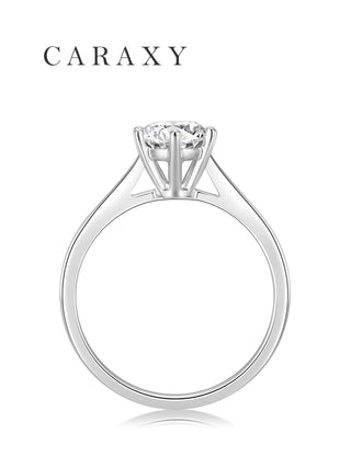 Side view of a six prong solitaire engagement ring showcasing the elegant cathedral setting.