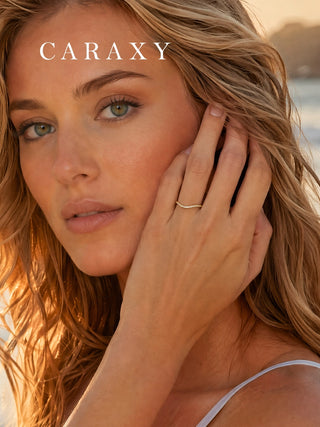 Model wearing a slim curved lab-grown diamond ring in 18K yellow gold as an everyday fine-jewelry piece.
