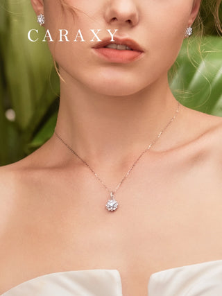 Model wearing a snowflake-inspired halo diamond necklace in 18K white gold for an elegant, slightly dressy look.