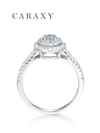 Side view of a blue diamond halo ring showcasing the elegant split shank and tiered setting