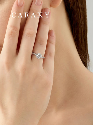 Close-up of a statement floral diamond ring on finger to show its brilliant scale.