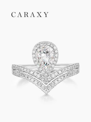Top view of a statement pear engagement ring with double V-shaped pavé bands.