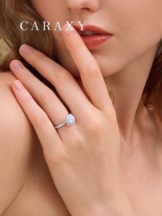 Close-up on finger showing the elegant cathedral setting and hidden diamond of the ring.