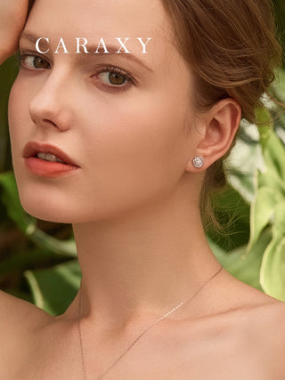 Model wearing swirl diamond studs in a close-up lifestyle view.