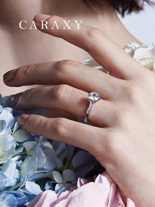 Close-up of a twisted band engagement ring worn on hand to show scale.