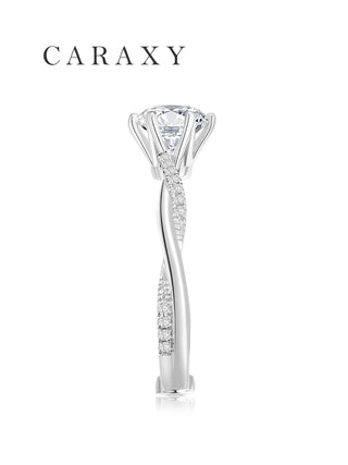 Side view of 18K white gold engagement ring with a twisted pavé band.