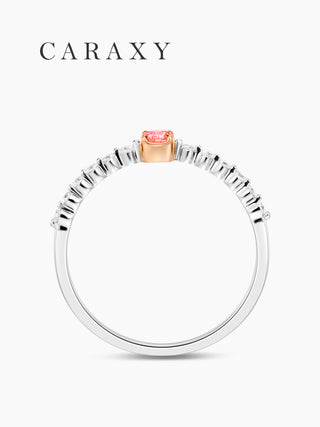 Side profile of a two-tone pink diamond ring with a round center stone and slim diamond band