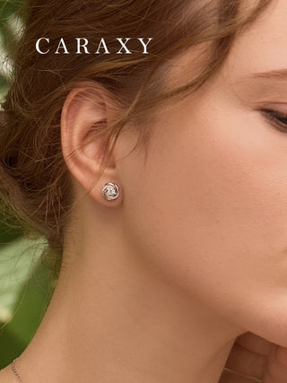 Unique diamond stud earrings shown on model with soft natural styling.