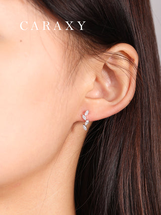 Vine diamond earrings shown on the ear with delicate nature-inspired styling.