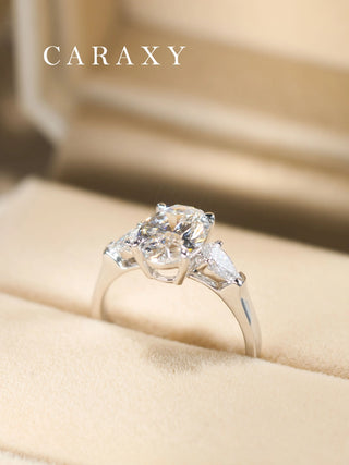 Vintage-inspired oval diamond three-stone ring presented in a premium jewelry box.
