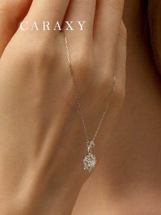 Detailed view of a white gold cluster pendant necklace with a feminine floral-like shape and radiant shine.