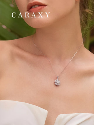 Model wearing a white gold diamond snowflake pendant necklace styled for an elegant everyday and holiday look.