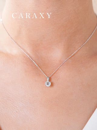 Close-up of a seed-inspired round diamond necklace worn on the neck