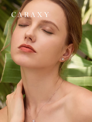 Model wearing white gold snowflake diamond earrings in an elegant lifestyle view.