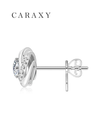 Side view of white gold swirl diamond earrings with polished posts and backs.