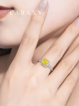 Close-up on finger showing the intense color of a fancy vivid yellow diamond ring.