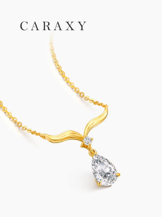 Side view of a pear-shaped diamond drop necklace in 18K yellow gold, highlighting the curved wing-inspired design and chain.